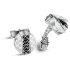 Silver-toned cufflinks with mother-of-pearl and black geometric. Round with square motifs; multi-faceted with openwork arm.