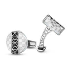 Silver-toned cufflinks with white MOP and geometric patterns. One round with black center, other rectangular with openwork ar