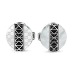 Silver-toned round cufflinks. One has monogrammed silver sides, the other white mother-of-pearl. Both with black geometric st
