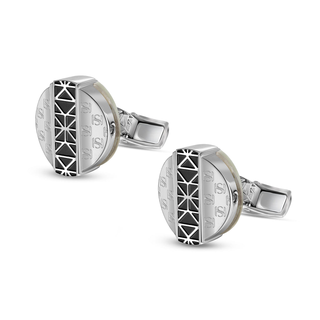 Pair of silver-toned cufflinks. Each round face features a black geometric pattern, 'S' monograms, and a creamy mother-of-pea