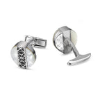 Silver-toned cufflinks with round mother-of-pearl faces and black geometric lattice. Monograms and 'CHAMP DE MARS' engraving