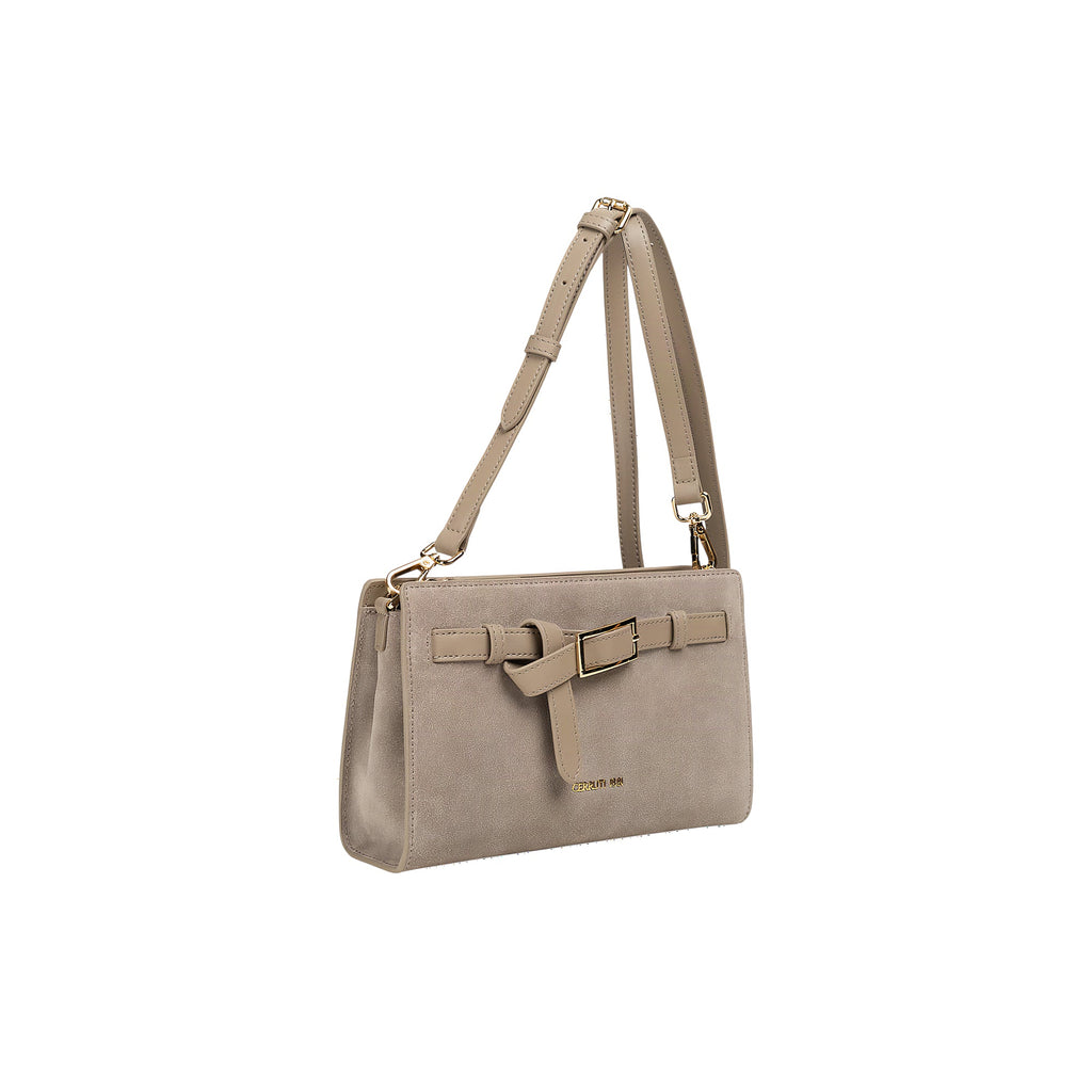 Taupe rectangular shoulder bag with a suede-like finish, a decorative front strap with a gold-toned buckle, and an adjustable