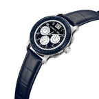 Silver-toned watch with a dark blue dial, three white subdials, and a date window, on a dark blue crocodile-embossed leather