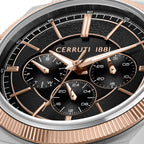 Silver-toned watch with a rose gold-toned fluted bezel and a black textured dial. Features gold-toned hands, hour markers, an