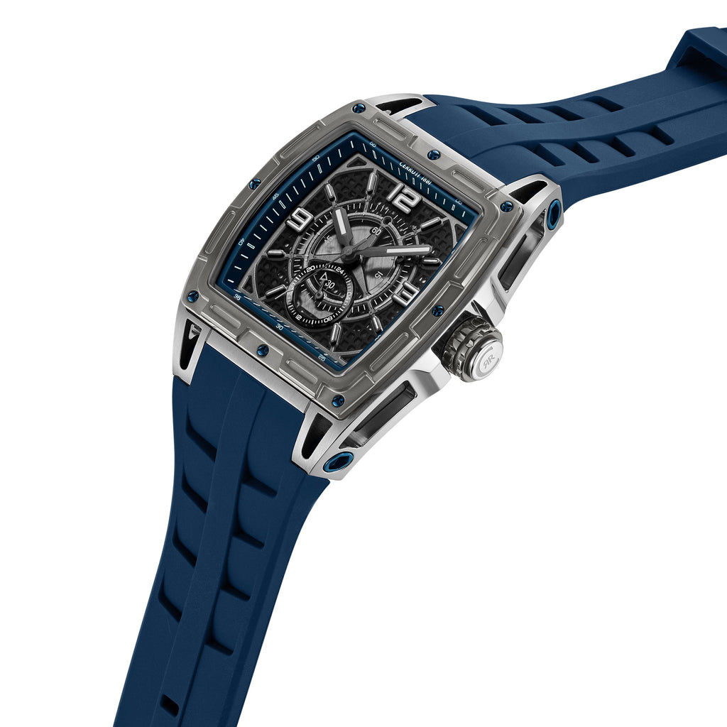Rectangular silver-toned watch with blue silicone strap. Dark blue textured dial, white markers, 6 and 12, two subdials.