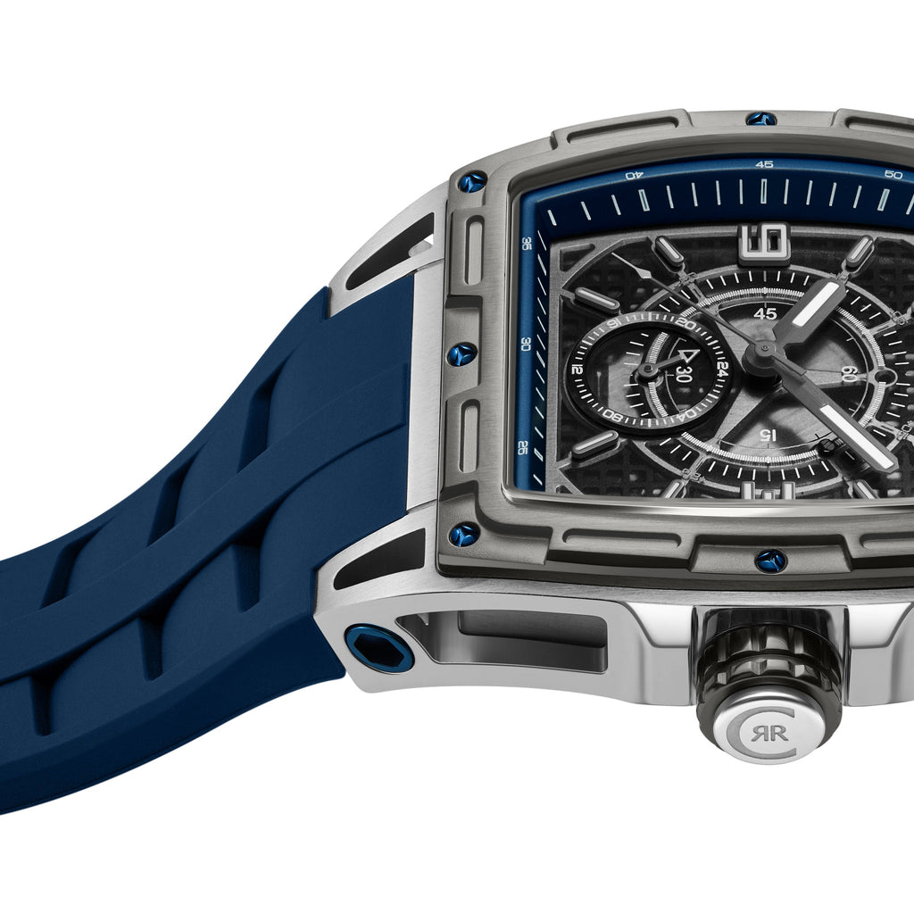 Silver-toned rectangular watch with blue accents, a dark blue textured dial, white hands, and a blue ribbed silicone strap.
