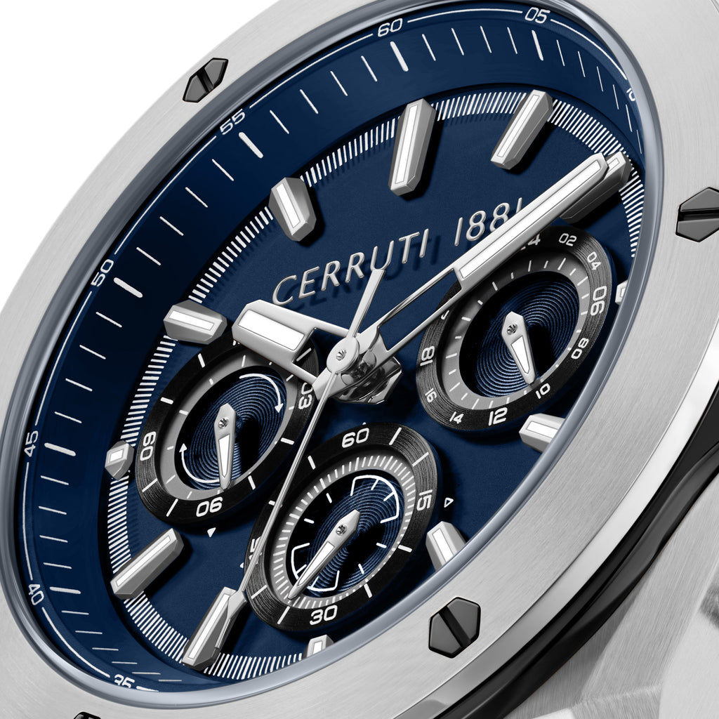 Silver-toned oval watch with a deep blue dial, silver-toned hands, rectangular markers, and three black-rimmed subdials.