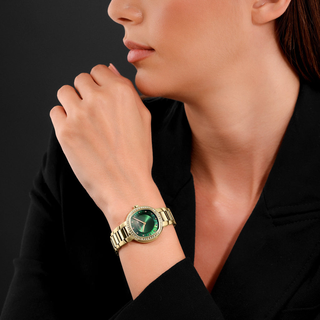 Gold-toned watch with a round case, crystal-encrusted bezel, green iridescent dial, and a link bracelet.