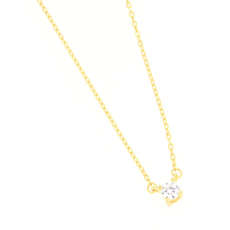 Gold-toned delicate link chain necklace with a single round, clear zircon stone in a four-prong setting.