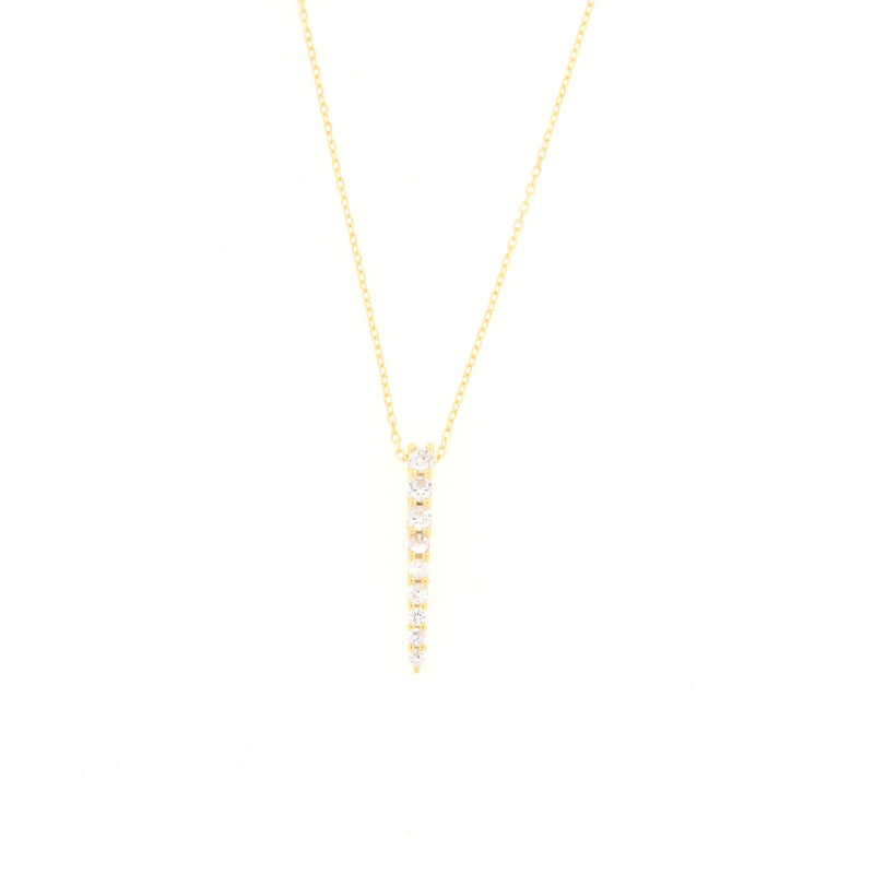 Delicate gold-toned chain necklace with a vertical, tapered pendant featuring a row of graduated clear stones.