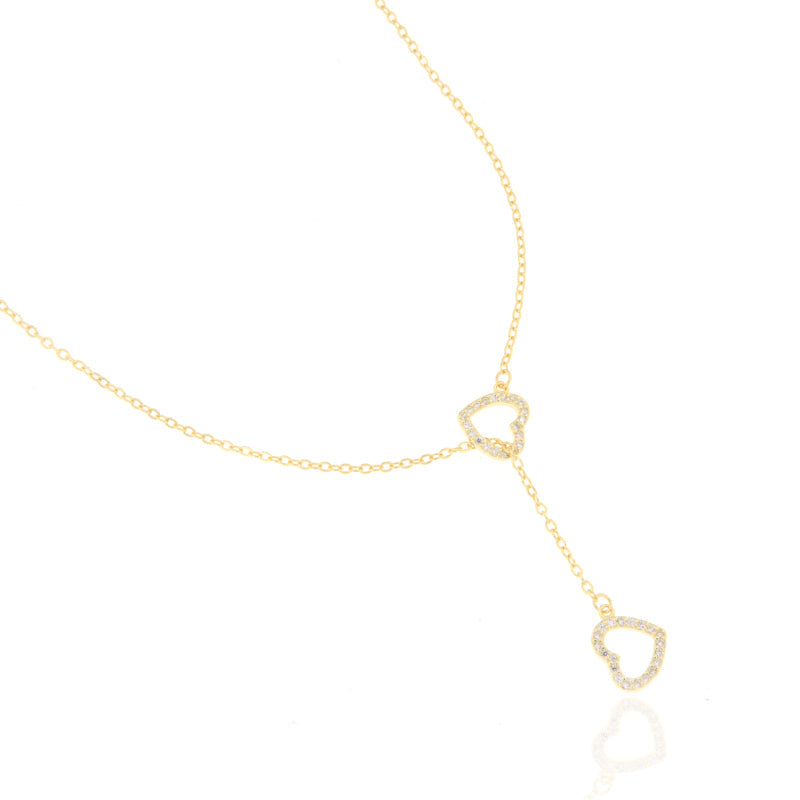 Gold-toned Y-drop necklace with two heart-shaped pendants, both outlined with clear pavé-set embellishments.