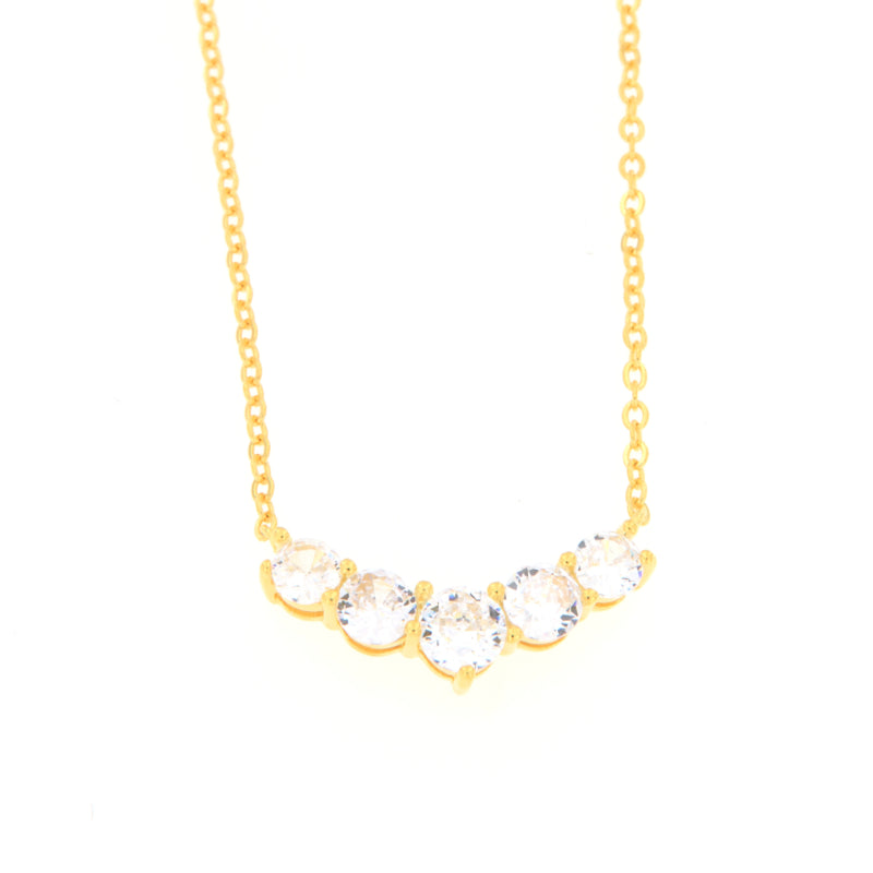 Gold-toned delicate chain necklace with five clear round faceted stones set in a curved bar.