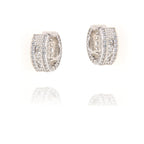 Pair of silver-toned hoop earrings, each embellished with pavé-set round clear stones and central baguette-cut clear stones.