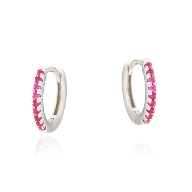 Pair of small silver hoop earrings, each adorned with a row of small, round, ruby-coloured faceted stones along the outer edg