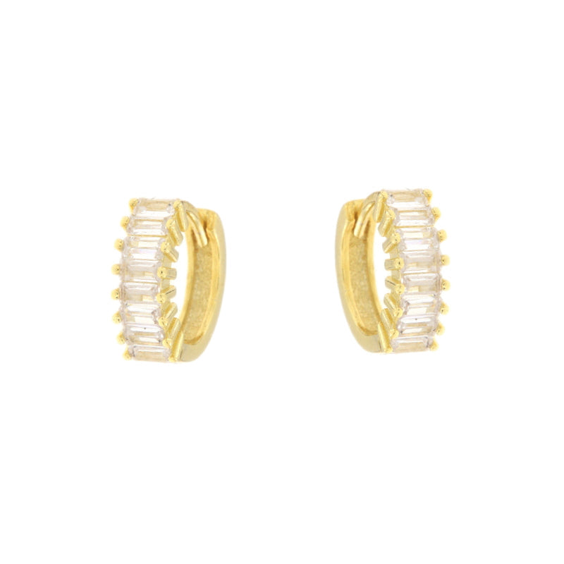 Pair of gold-toned huggie hoop earrings featuring a row of clear baguette-cut stones along the front.