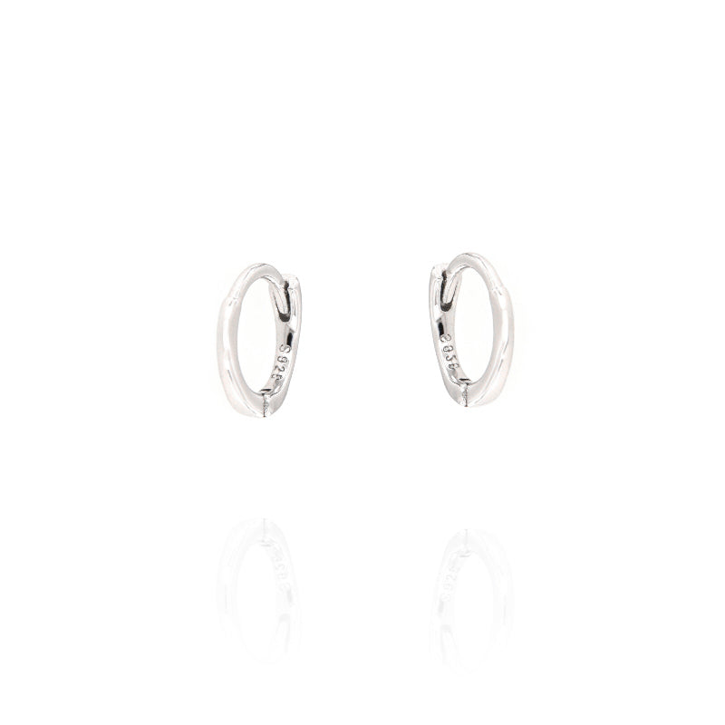 Pair of small, polished silver-toned hoop earrings with a hinge closure, each stamped 'S925'.