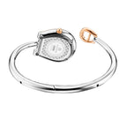 A rear angle perspective highlighting the polished stainless steel caseback engraved with the model number AGW271005S and Flora collection name, alongside the inner curve of the open bangle bracelet and the contrasting rose gold crown.