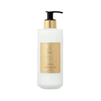Frosted white glass bottle of Creed Aventus Hand & Body Lotion with a black pump and gold-toned collar and label.