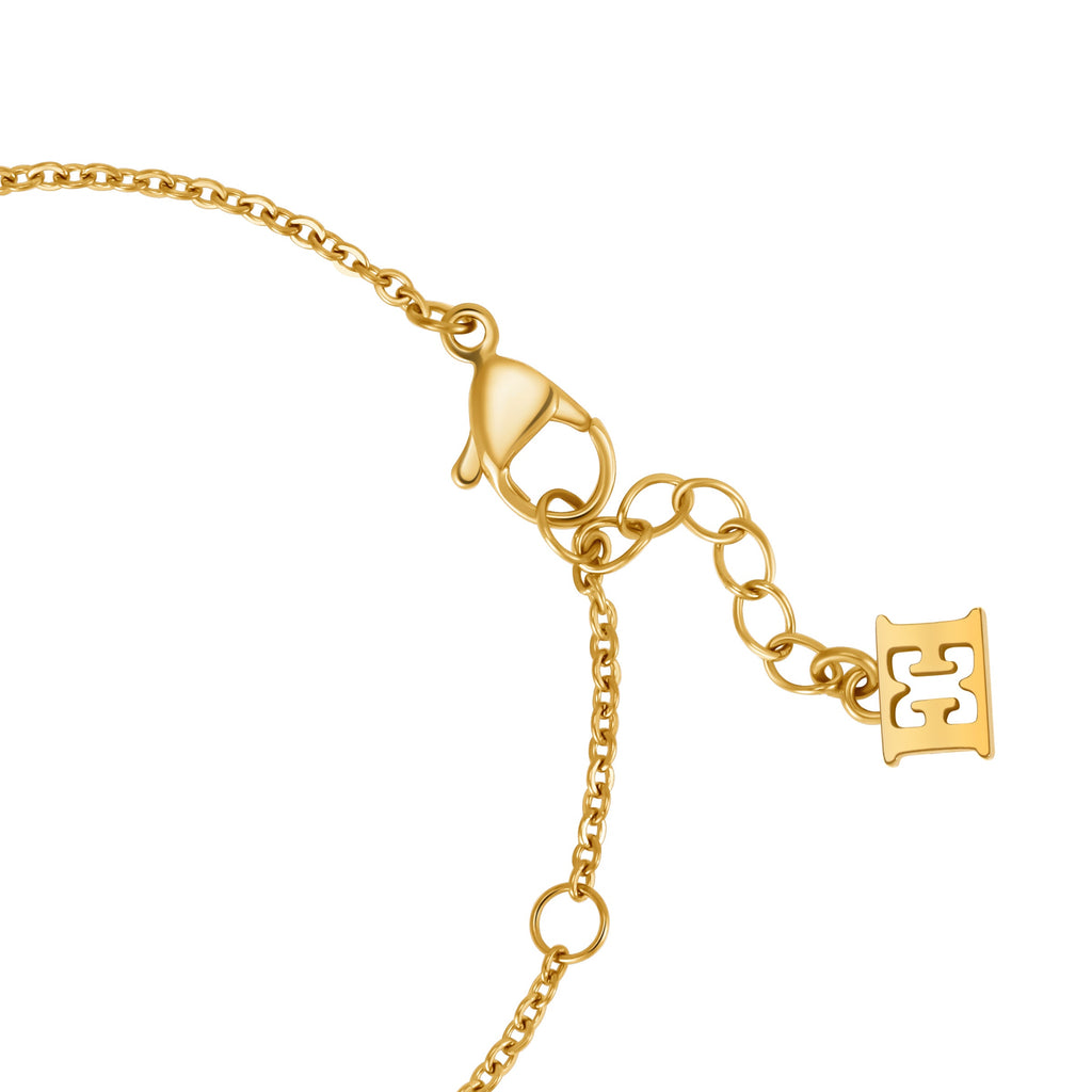 Gold-toned bracelet with a lobster clasp, an extender chain, and a small rectangular charm with a cutout logo.