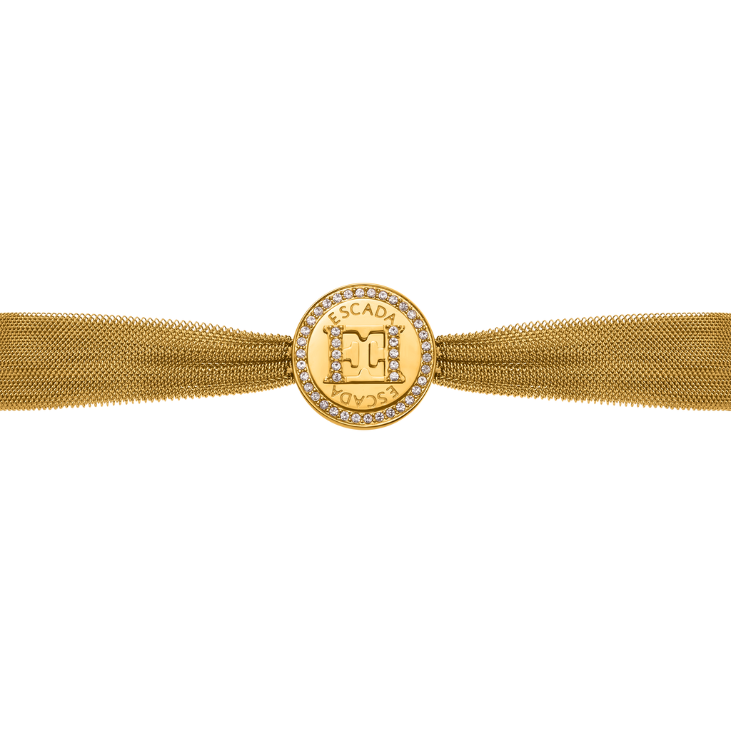 Gold-toned mesh bracelet with a round medallion featuring a crystal-studded "M" logo and "ESCADA" text, framed by crystals.