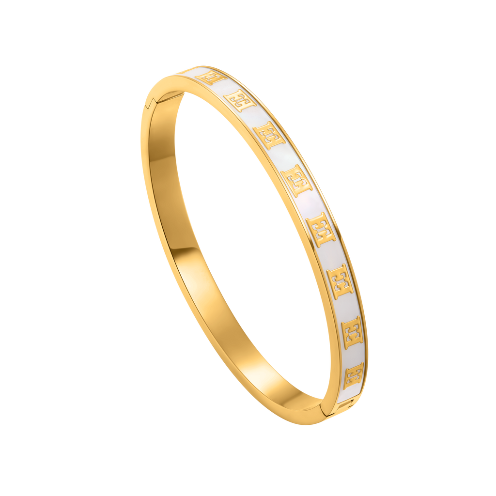 Gold-toned hinged bangle bracelet with a white band featuring repeated gold-toned 'E' logos on the top half.