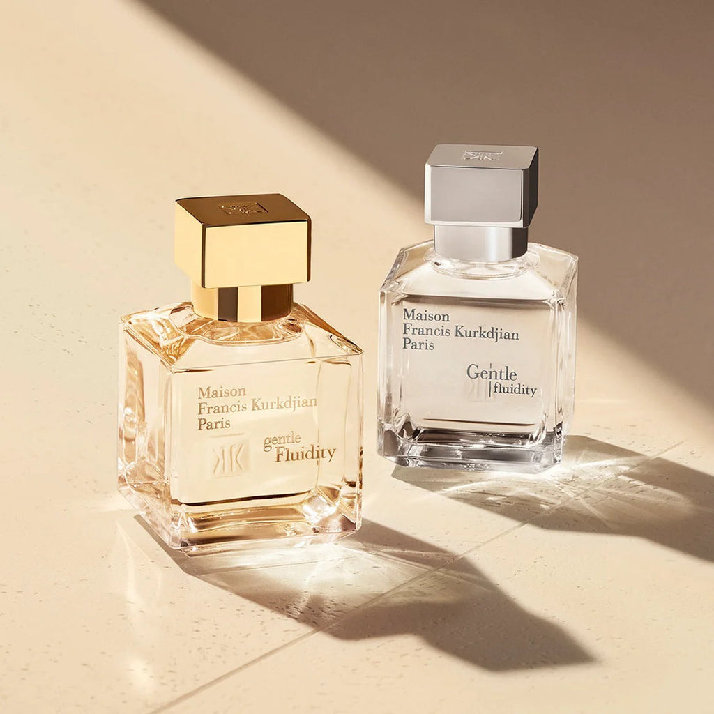 Clear rectangular glass perfume bottle with a silver-toned square cap and a white label.