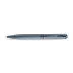 A high-resolution studio shot of the Aigner Ettoro men's luxury ballpoint pen displayed horizontally, highlighting its textured gunmetal-blue and chrome brass barrel, the central engraved Aigner brand band, the integrated pocket clip, and the exposed fine writing tip.