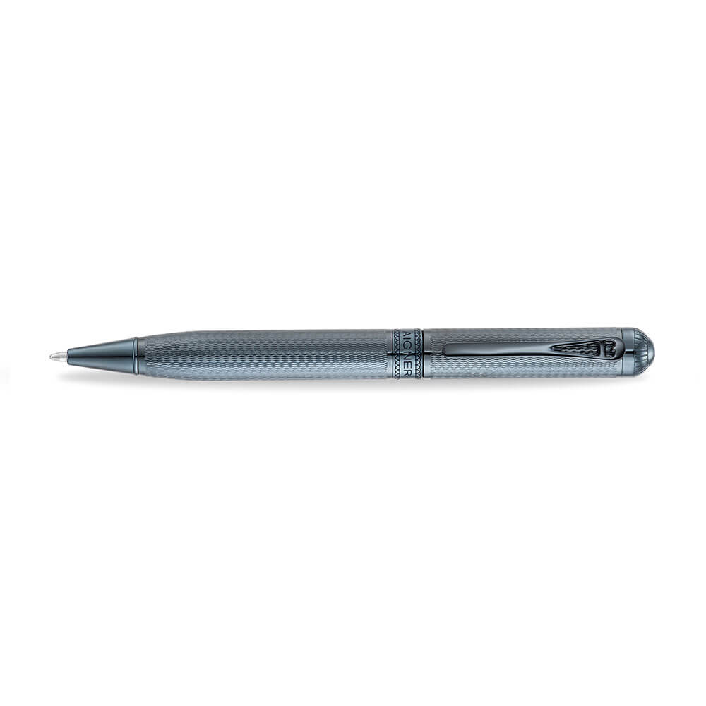 A high-resolution studio shot of the Aigner Ettoro men's luxury ballpoint pen displayed horizontally, highlighting its textured gunmetal-blue and chrome brass barrel, the central engraved Aigner brand band, the integrated pocket clip, and the exposed fine writing tip.