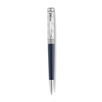 A high-resolution studio presentation of the Aigner Modeno Due men's luxury ballpoint pen displayed horizontally against a white background, highlighting its brass barrel finished with a smooth midnight-blue lower grip, a silver-tone cap engraved with diagonal spiraling grooves, a vertical Aigner logo on the central silver band, a sleek pocket clip, and the exposed fine writing tip.