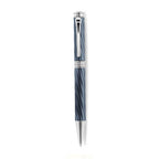 A high-resolution studio presentation of the Aigner Modeno Due men's luxury ballpoint pen displayed horizontally, highlighting its brass barrel finished in an engraved, spiraling blue-grey fluted pattern, the central silver band with a vertical Aigner logo, a sleek chrome pocket clip, and the exposed fine silver writing cone.