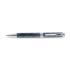 A high-resolution studio presentation of the Aigner Modeno Due men's luxury ballpoint pen displayed horizontally, highlighting its brass barrel finished in an engraved, spiraling blue-grey fluted pattern, the central silver band with a vertical Aigner logo, a sleek chrome pocket clip, and the exposed fine silver writing cone.