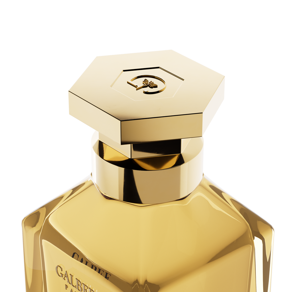 A close-up detail shot of the golden hexagonal cap on the Galbee Paris bottle, showcasing the delicate bee engraving on the top surface.