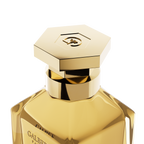 A close-up detail shot of the golden hexagonal cap on the Galbee Paris bottle, showcasing the delicate bee engraving on the top surface.