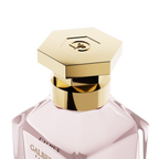 A close-up detail shot of the golden hexagonal cap on the Galbee Paris bottle, showcasing the delicate bee engraving on the top surface.
