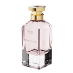 A three-quarter perspective view of the Oh My Galb perfume bottle, showing its clear glass base, soft pink interior, and hexagonal gold cap.