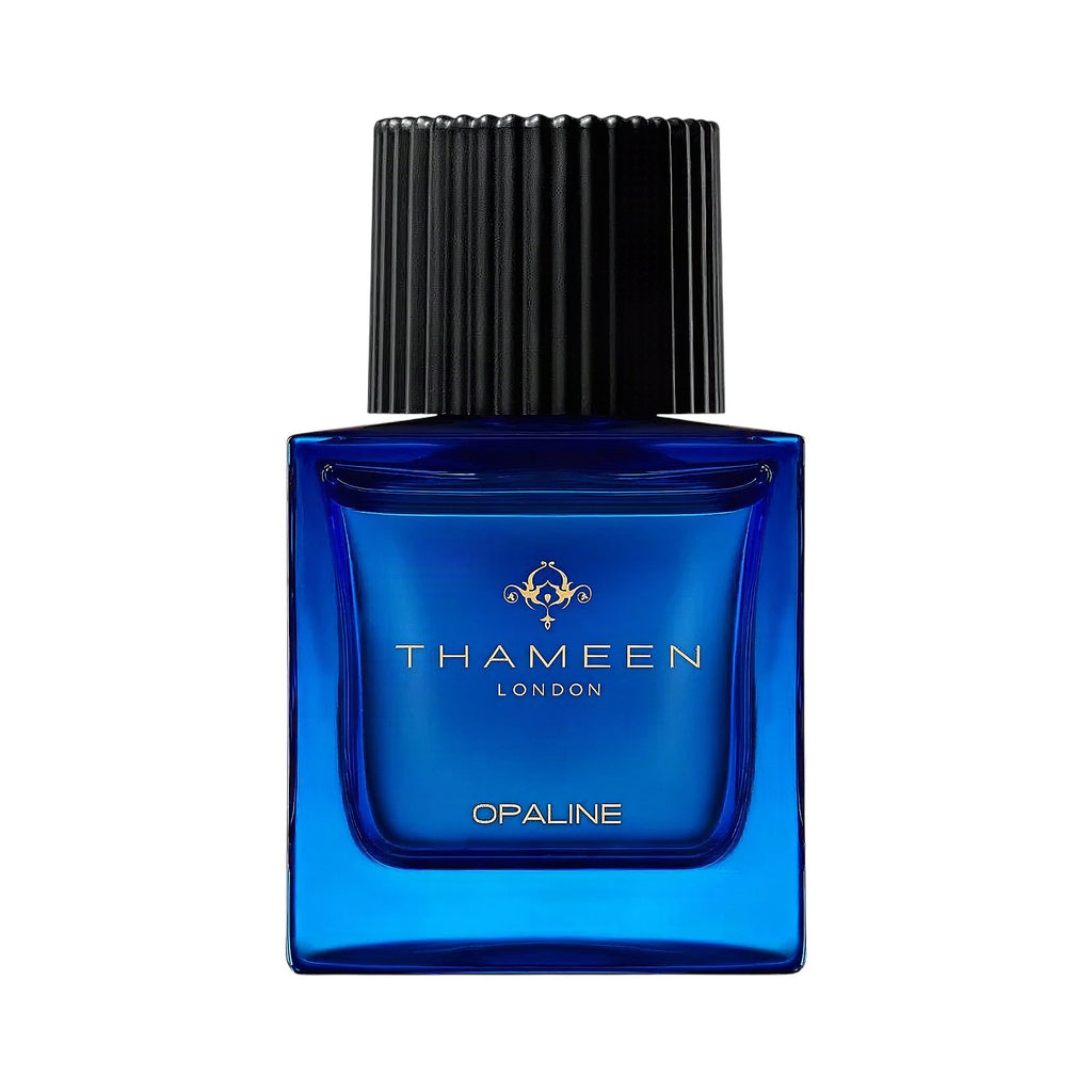 Blue rectangular glass perfume bottle with a black ribbed cap and gold-toned THAMEEN logo.