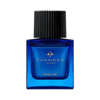 Blue rectangular glass perfume bottle with a black ribbed cap and gold-toned THAMEEN logo.
