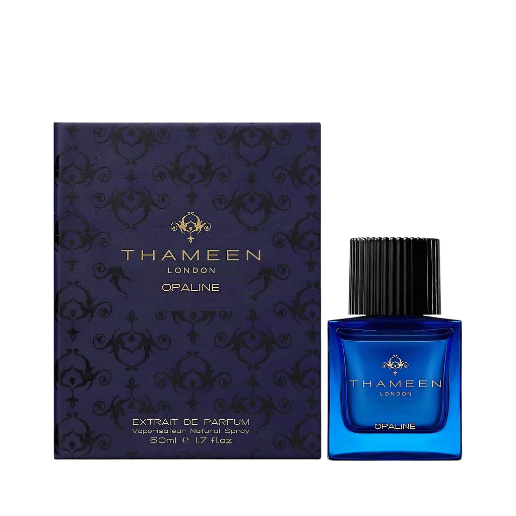 Dark blue box with ornate pattern and gold-toned text, next to a square deep blue perfume bottle with a black ribbed cap.