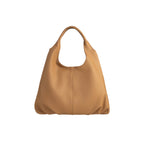 Warm beige pebbled leather hobo bag with a single curved shoulder strap and a vertical seam down the front.