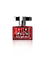 The Kajal Ruby Eau De Parfum bottle presented alongside its textured silver and red metallic packaging.