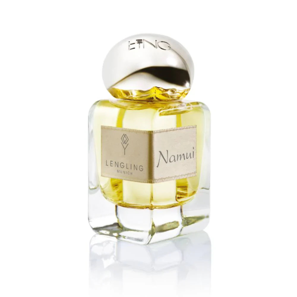 A close-up of the Lengling Munich Namui Extrait de Parfum glass bottle, showcasing the gold-hued fragrance, silver cap, and signature fabric label.