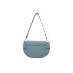 Dusty blue pebbled leather half-moon bag with a flap closure, two horizontal straps, a matching shoulder strap, and gold-tone