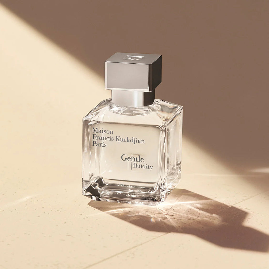 Square clear glass perfume bottle with a silver-toned square cap. Black text on the front reads 'Maison Francis Kurkdjian Par