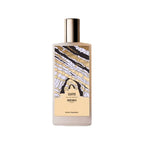 A white bottle of Memo Paris Zante Eau de Parfum standing next to its tan textured presentation box. The bottle features a colorful, abstract illustration of coastal rock formations.