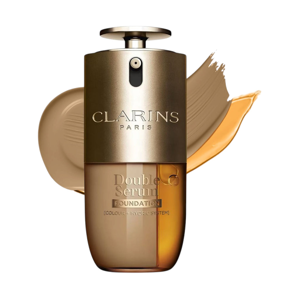 Gold-toned pump bottle with opaque top, clear bottom showing light brown and amber liquid layers. Clarins Double Serum Founda