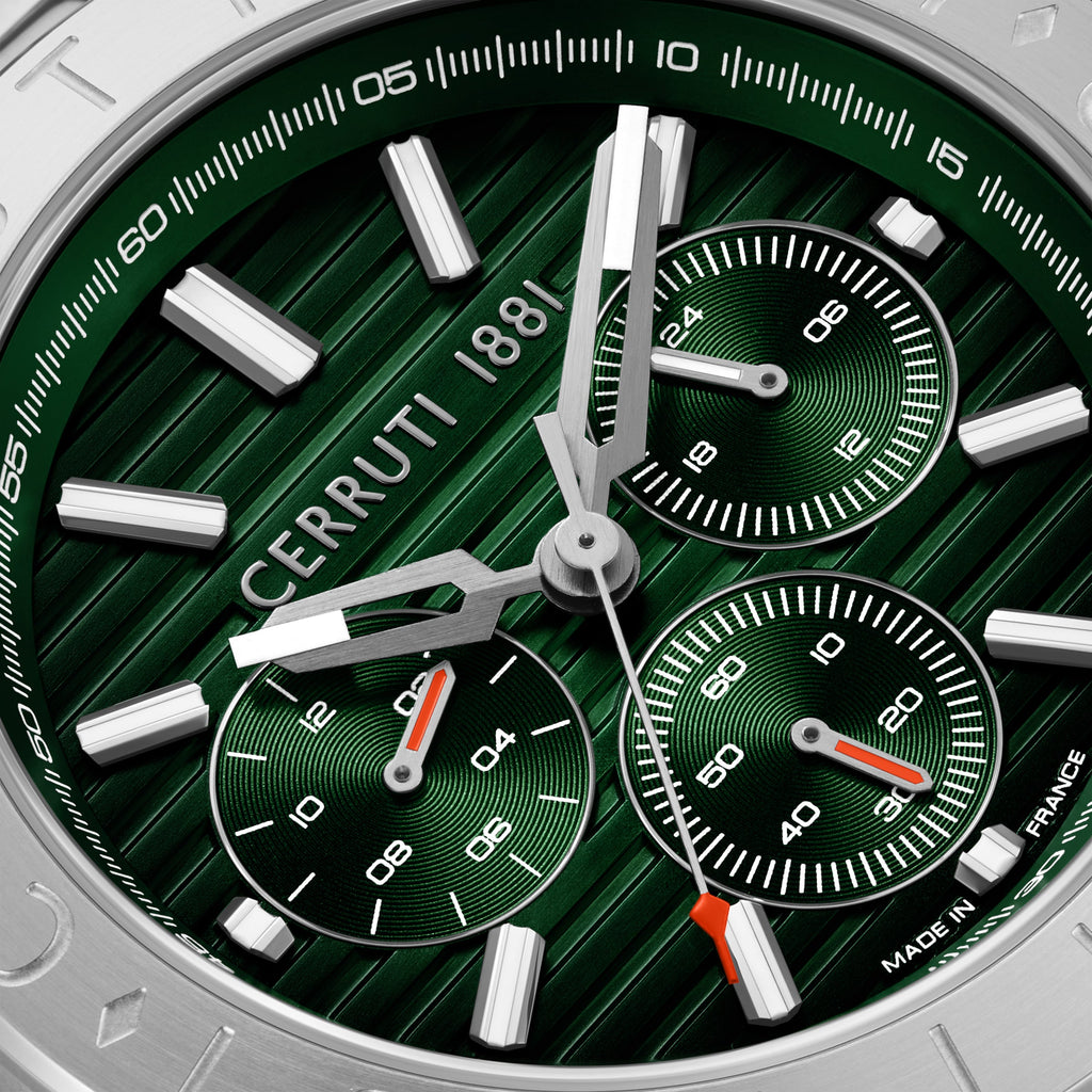A close-up macro product photograph detailing the green sunray ridge pattern of the Filiano dial, luminous silver hour bars, and the fine concentric snailing on the multi-function sub-dials.