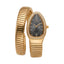 Gold-toned Monteva ladies' watch with a coiled bracelet, an elongated case, dark grey dial, and clear stones on the bezel and