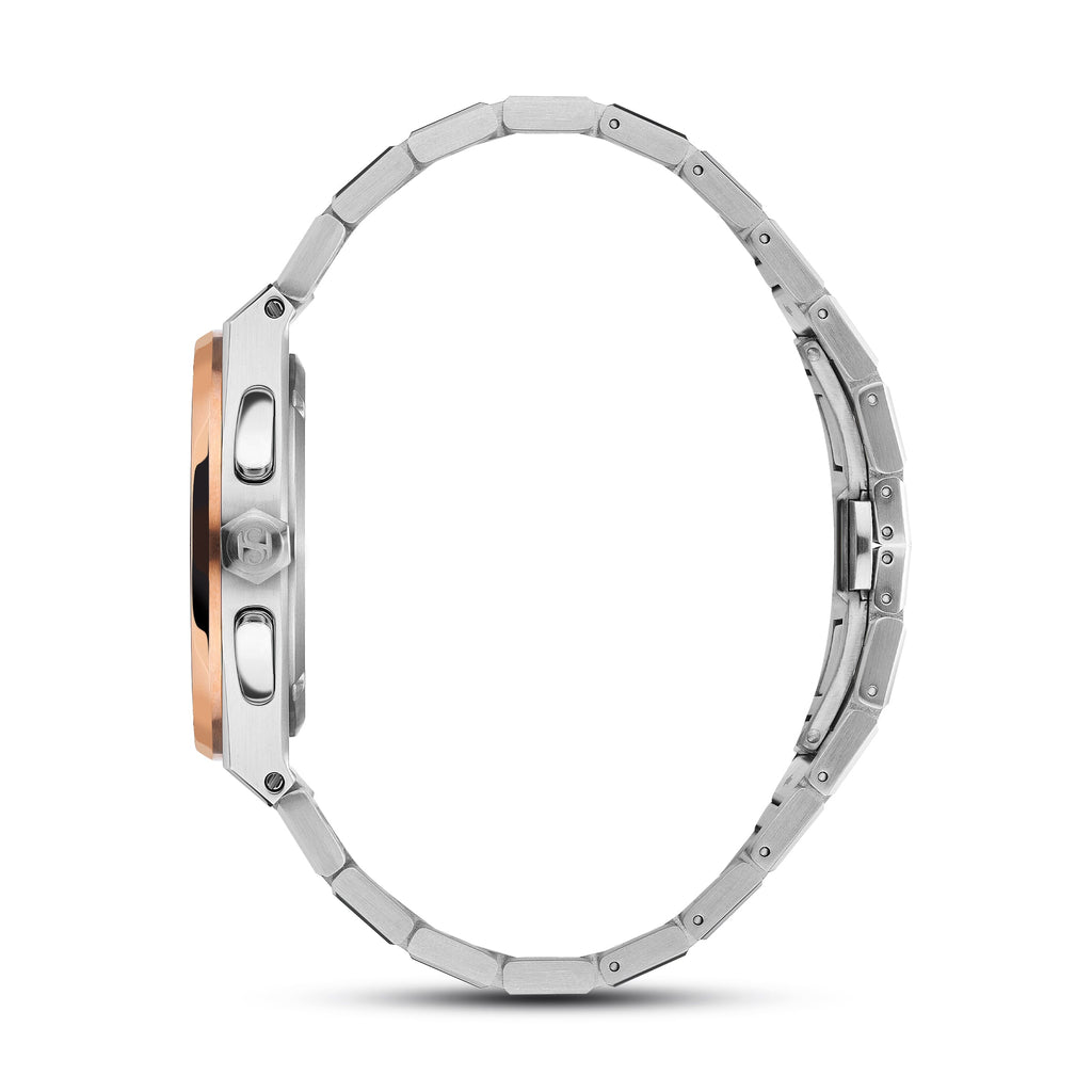 Side view of a silver-toned watch with a rose gold-toned bezel, two pushers, and a crown. It has a silver-toned metal link br