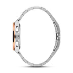 Side view of a silver-toned watch with a rose gold-toned bezel, two pushers, and a crown. It has a silver-toned metal link br