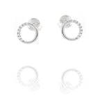 A pair of silver-toned stud earrings, each featuring an open circle design. One arc of the circle is smooth, the other is set